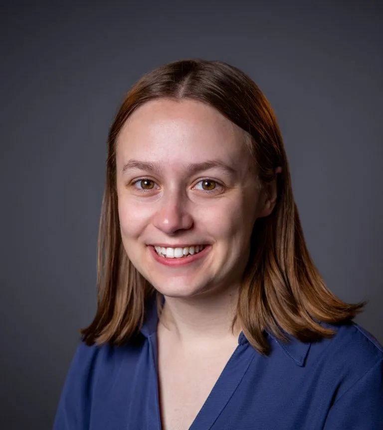 Sarah Hartmann smiling in a blue top.