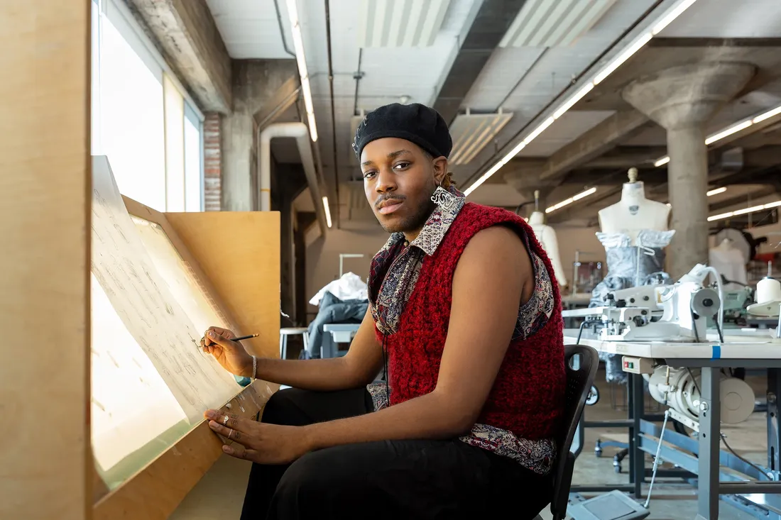 Jacieon “Jace” Williams ’24 sitting and working on a fashion project.