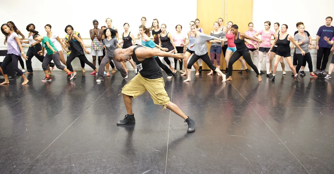 Anwar Nasir teaching dance class to adults.