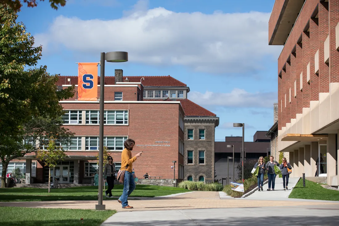 A person walking on a college campus.