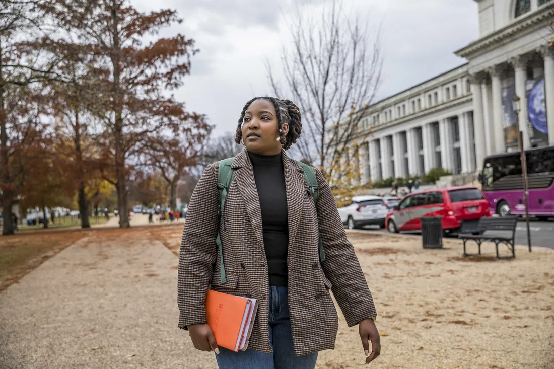 Maxwell School of Citizen and Public Affairs Marriler Wilson, studying away in Washington D.C., carrying an orange folder.