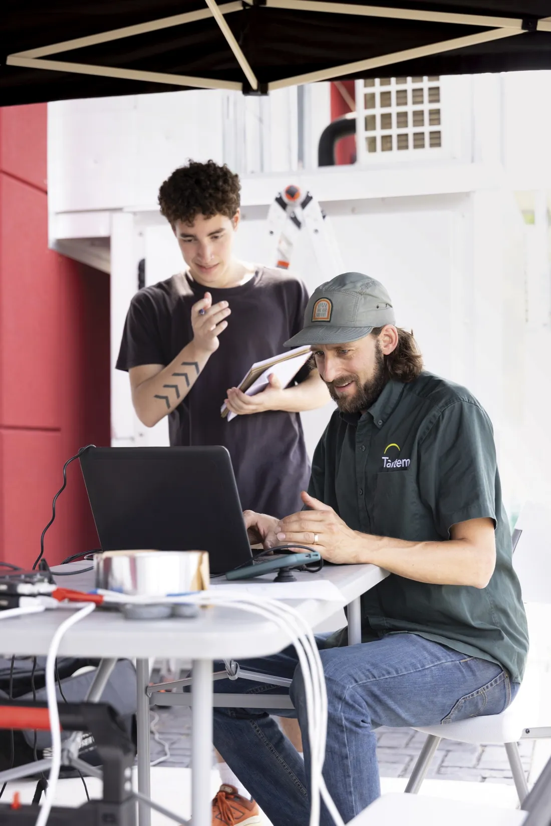 Student and faculty member working on a computer to analyze information for South Campus's apartment retrofitting.