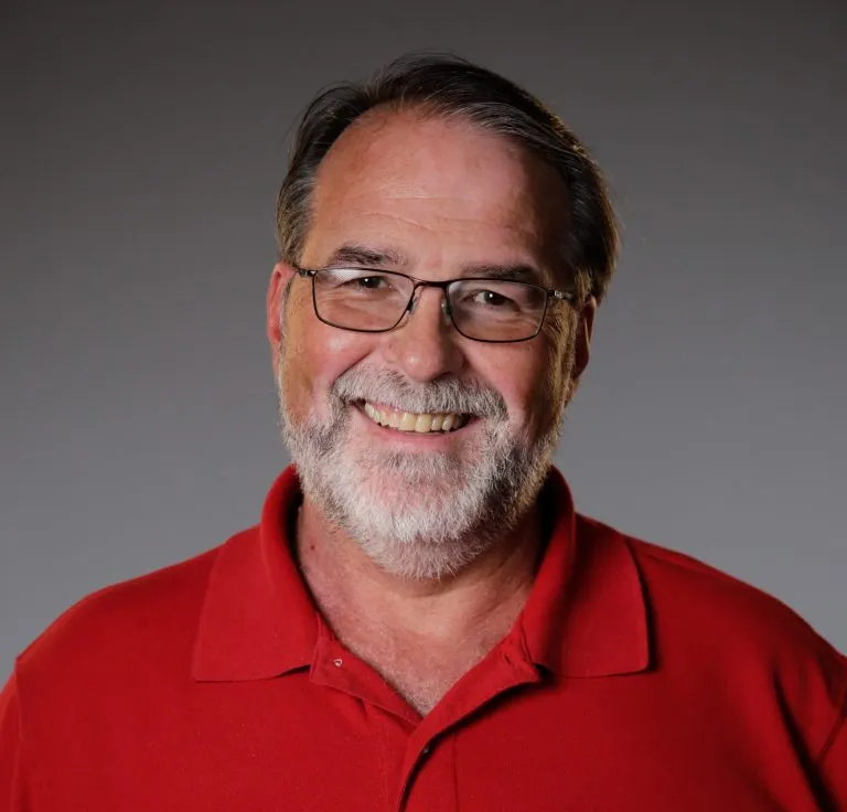 Rich Pitzeruse smiling in a red polo.