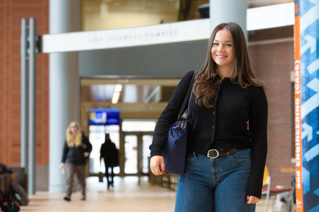 Person standing and smiling.