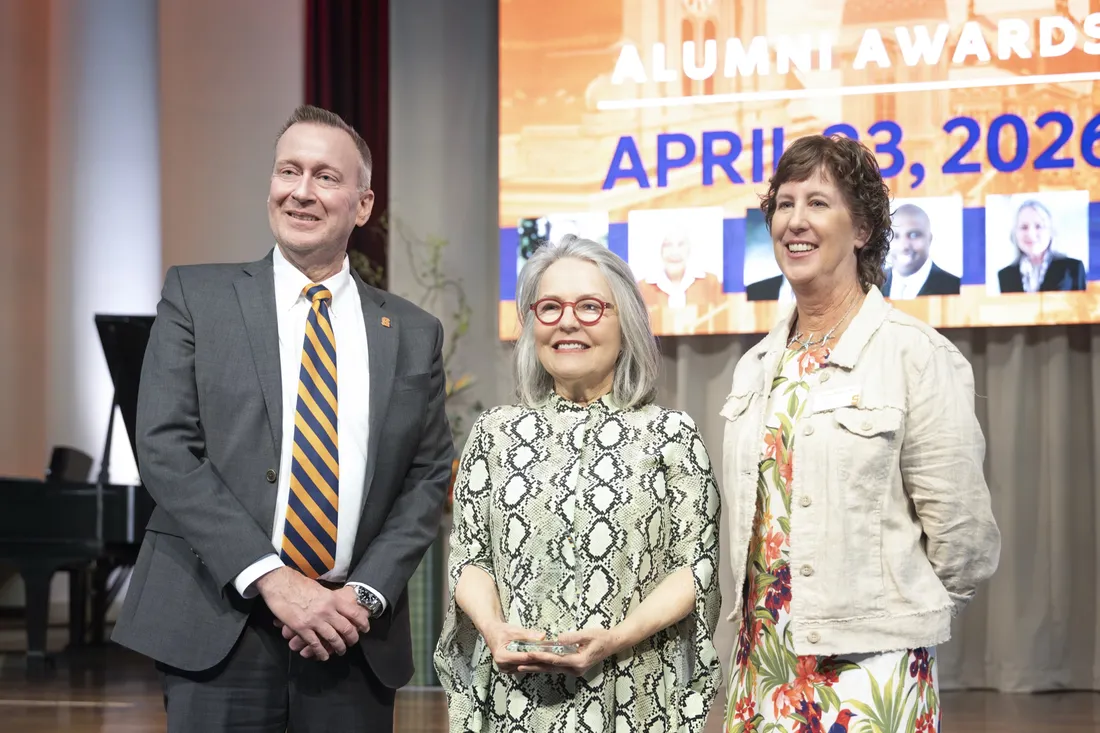 Diana Wege '76 standing with Chancellor Haynie and Christine Abbott G'86 at the Alumni Awards Celebration.