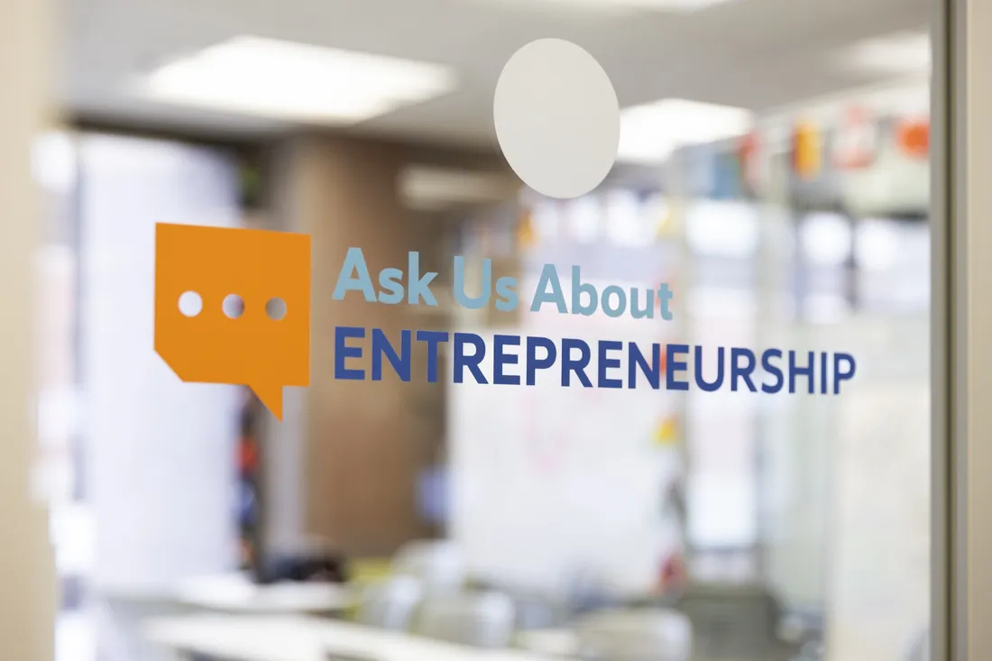 Window of the Bird Library's Blackstone Launchpad space, with an orange text bubble next to the words "Ask About Entrepreneurship."