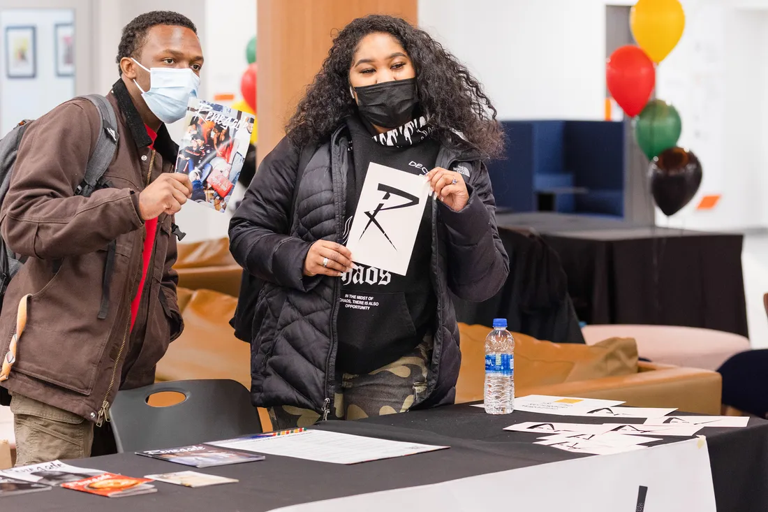 Two students posed with copies of Renegade Magazine.