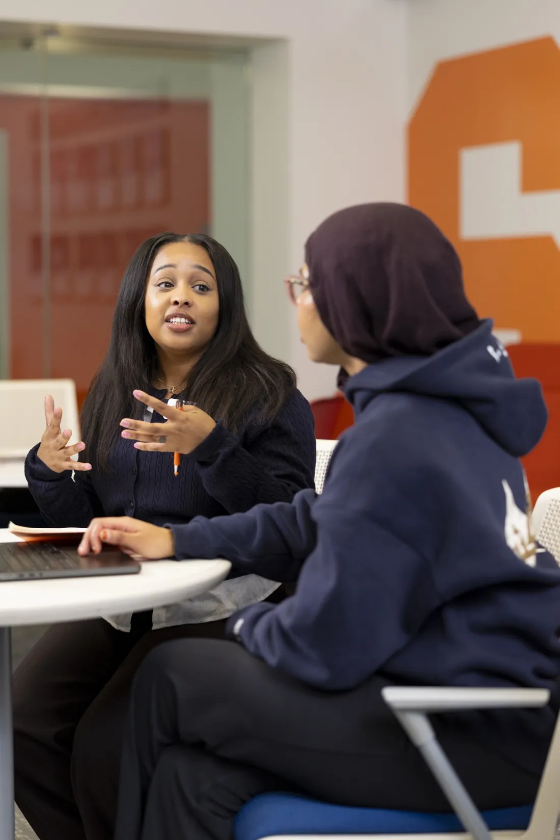 Indaria Jones '14 speaking with a student at the Couri Hatchery Business Incubator.