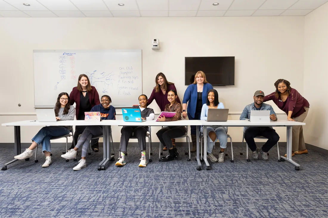 A student support group sitting at a table.