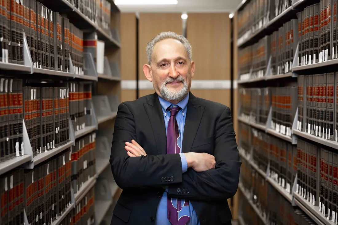 Professor David Driesen standing in the library.