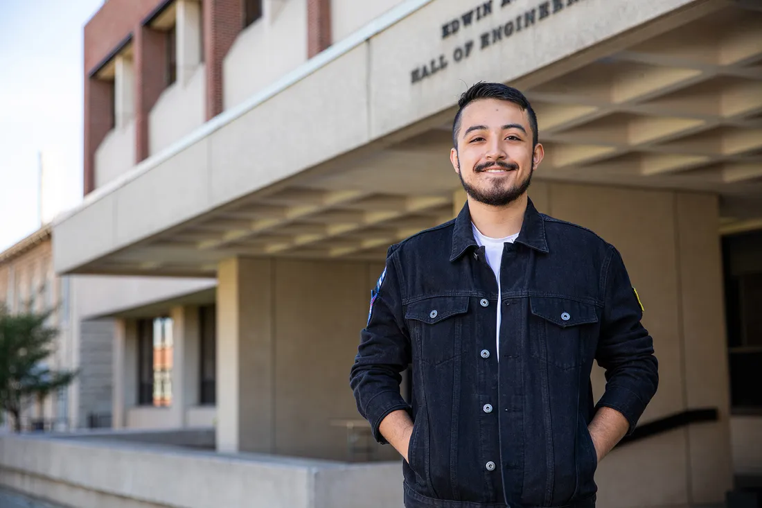 Elliott Salas poses for portrait outside of campus building.