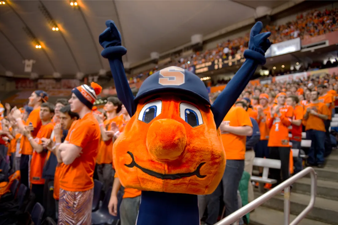 Otto cheering in front of students in the Dome.