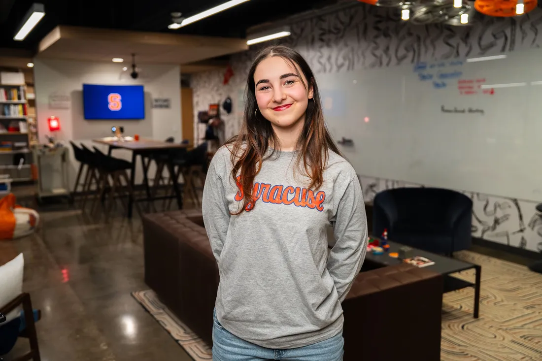 Student standing and smiling.