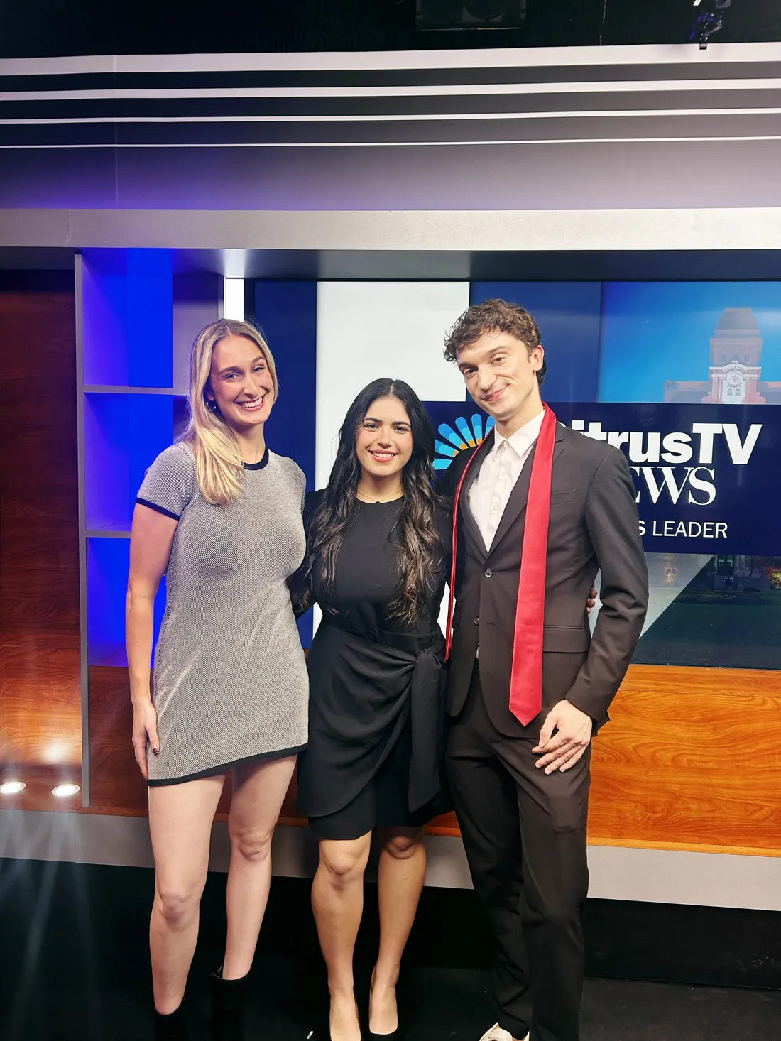 Alexa Korrie '28 standing with fellow CitrusTV students inside of a CitrusTV studio.