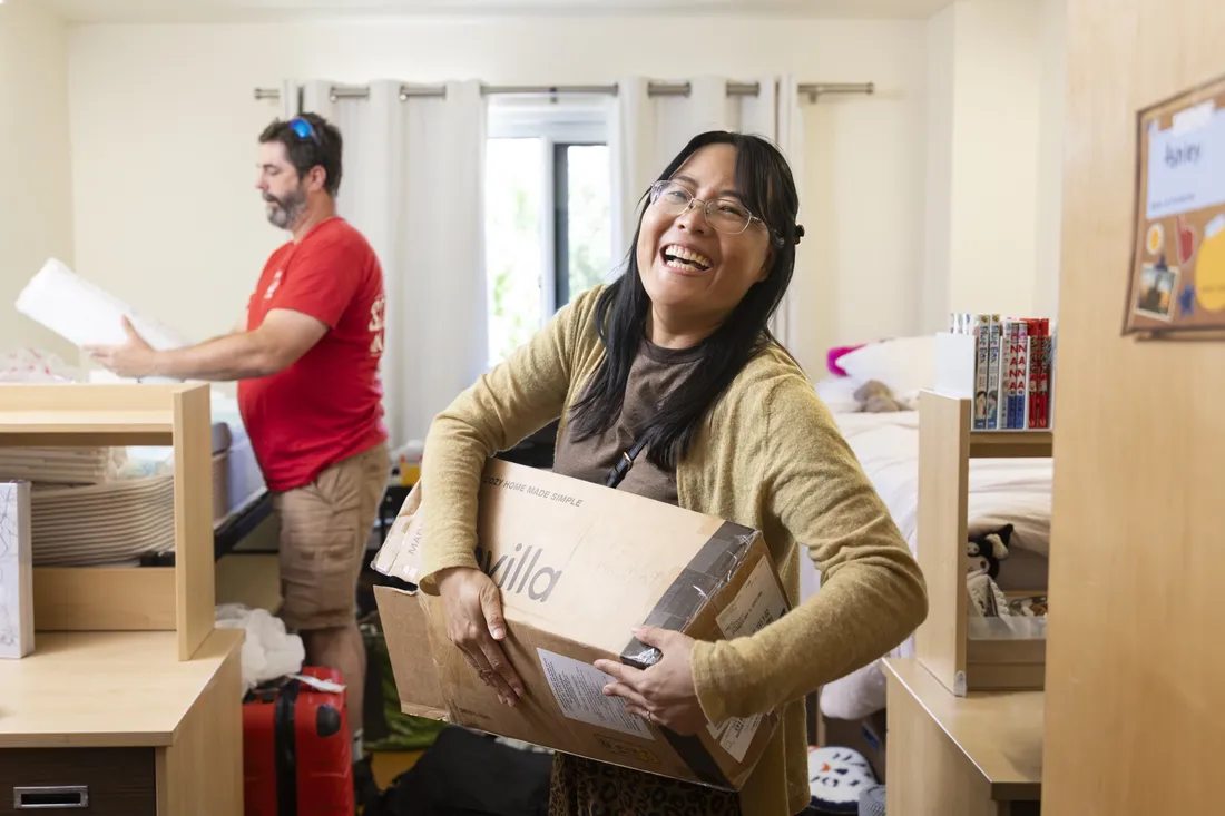 Xihui Newman moving boxes into her daughter's residence hall.