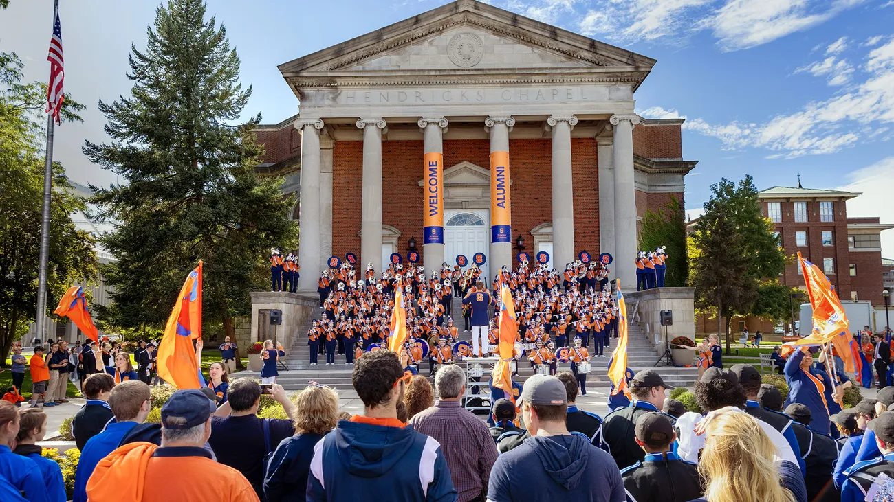 Students and the marching band on the quad during the Orange Central tailgate.