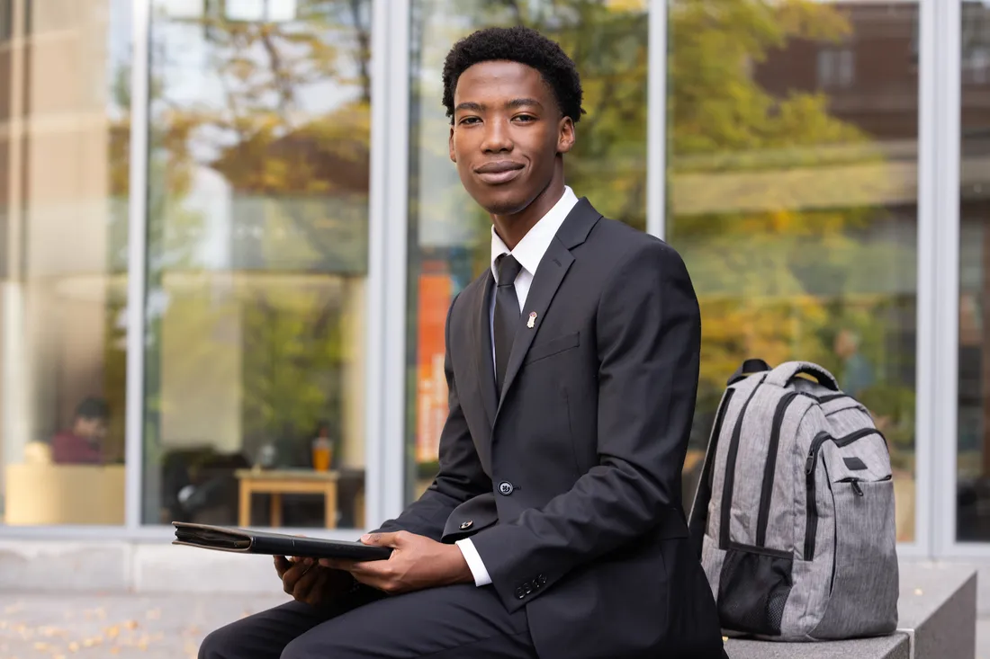 Student sitting and smiling.