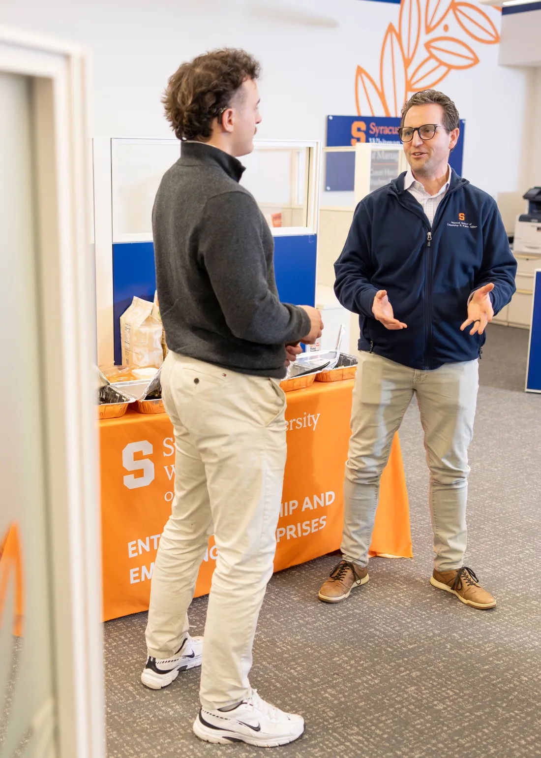 Student speaking with alumnus Peter Forsgren at a business networking event.