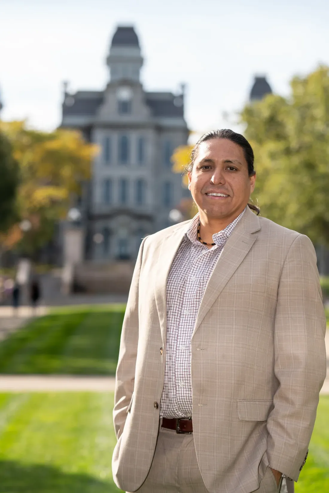 Neil Powless standing in front of the Hall of Languages.