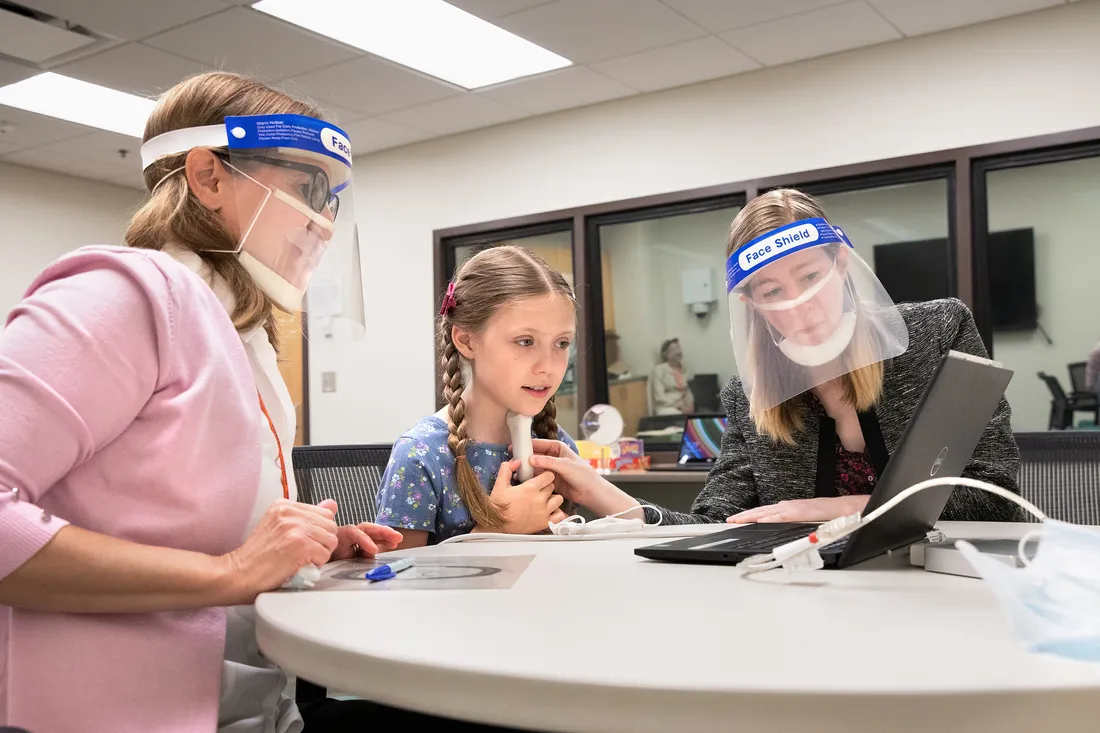 Speech pathologist and children work together in a clinic.