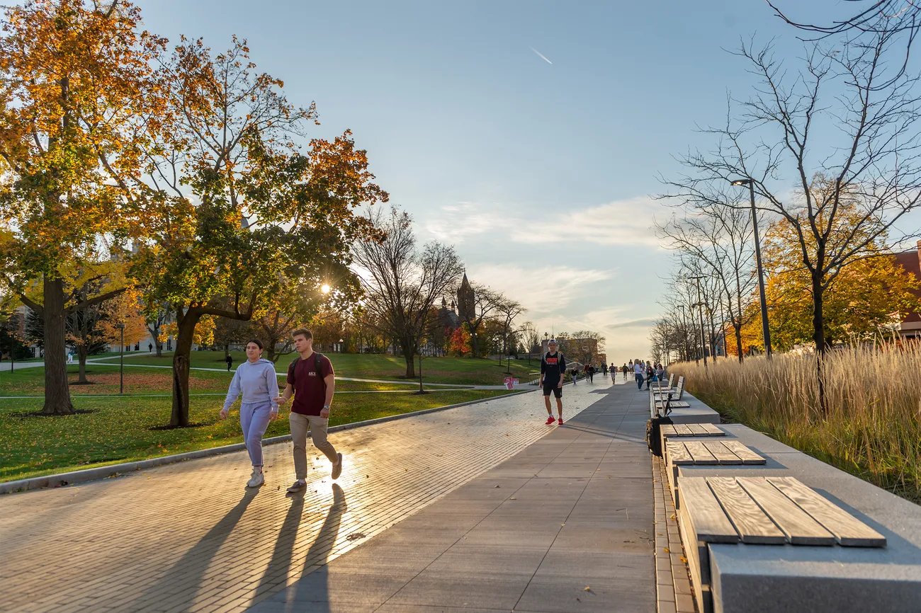 Students walking on campus in the fall.