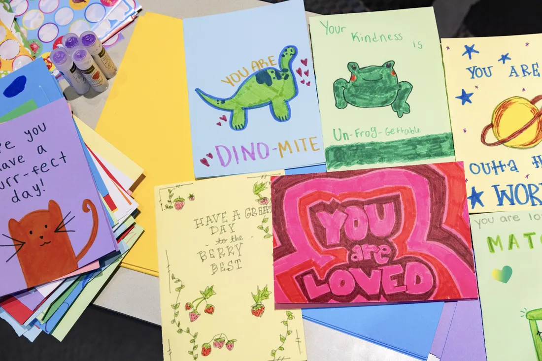 Various holiday cards with uplifting messages and drawings on them.