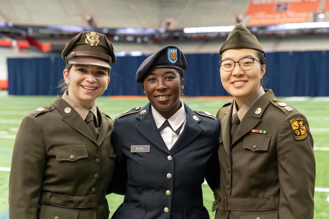 Army ROTC and Air Force ROTC students standing and smiling togehter.