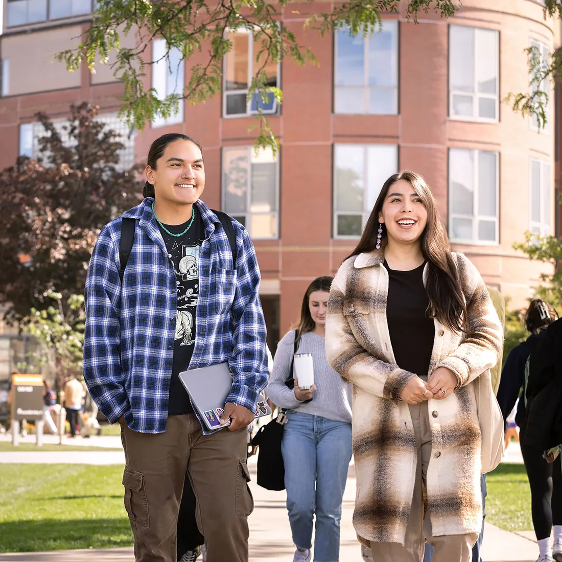 Two students walking on campus.