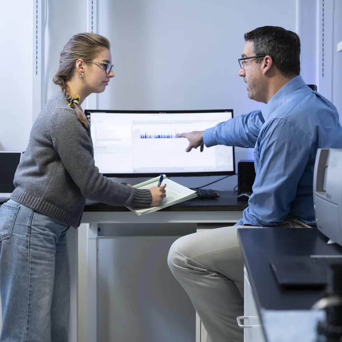 Professor Michael Marciano G’18 working with Matilda Nichols ’27 in a lab.