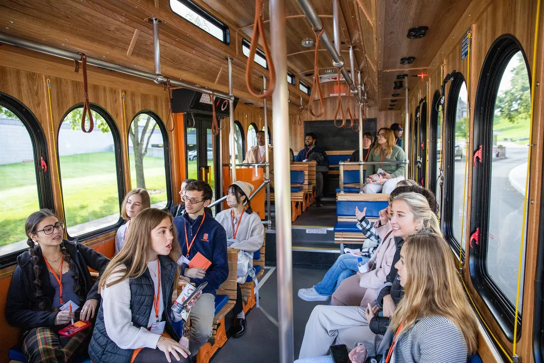 Students on a 'Cuse Trolley talking to each other.