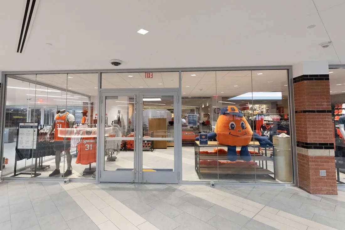 Look into the Schine campus store front, Otto viewable in the window.