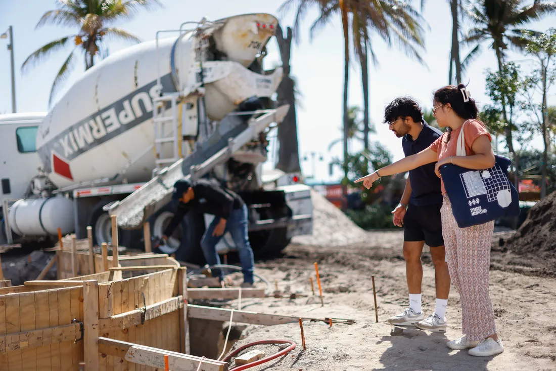 People pointing at something outside in Miami.