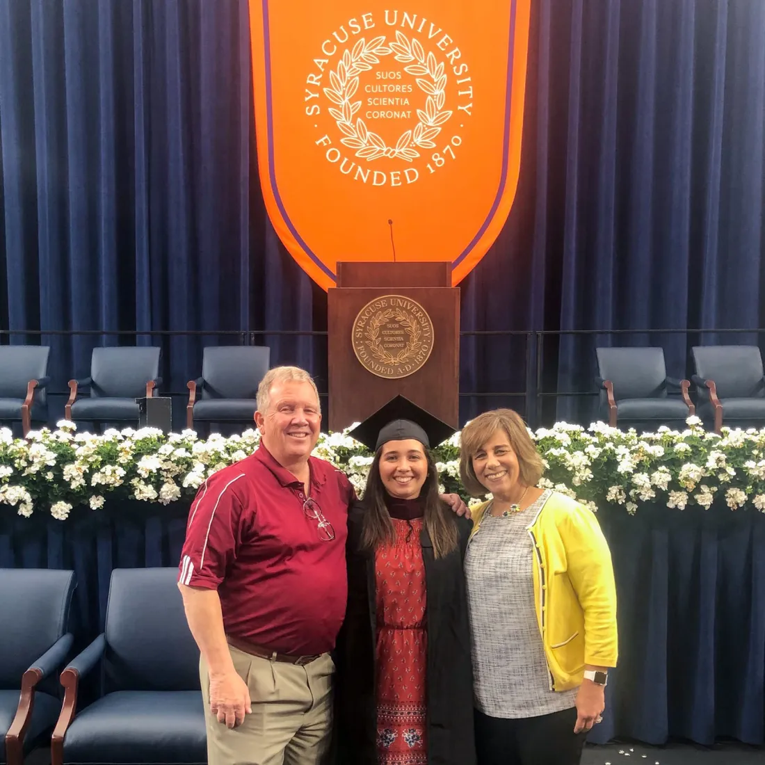 Nina Lindberg and her family standing together and smiling at Commencement.