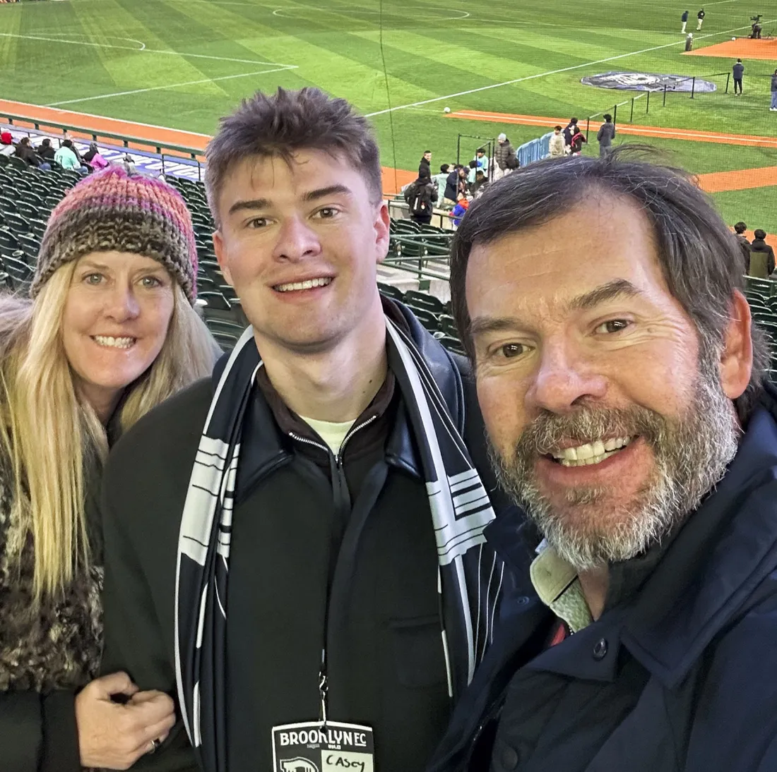 Student Casey Hornbeek at a soccer game with his parents.