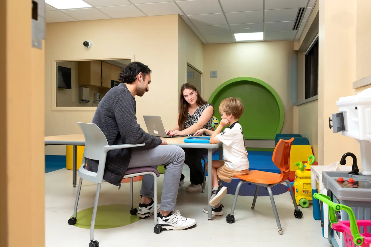 Gabby Garcia ’27 working with a child and their parent at the Golisano Center for Special Needs.