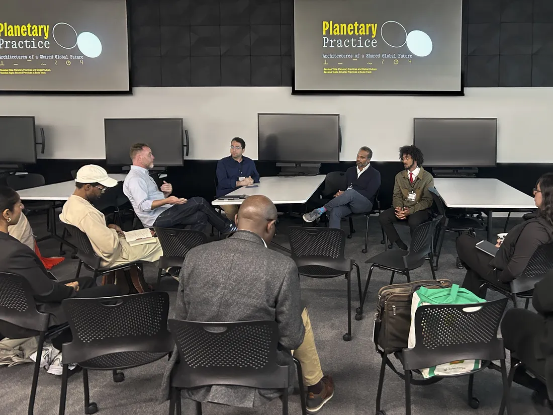 Jon Carter '26 sitting in a circle of other business leaders at a conference.