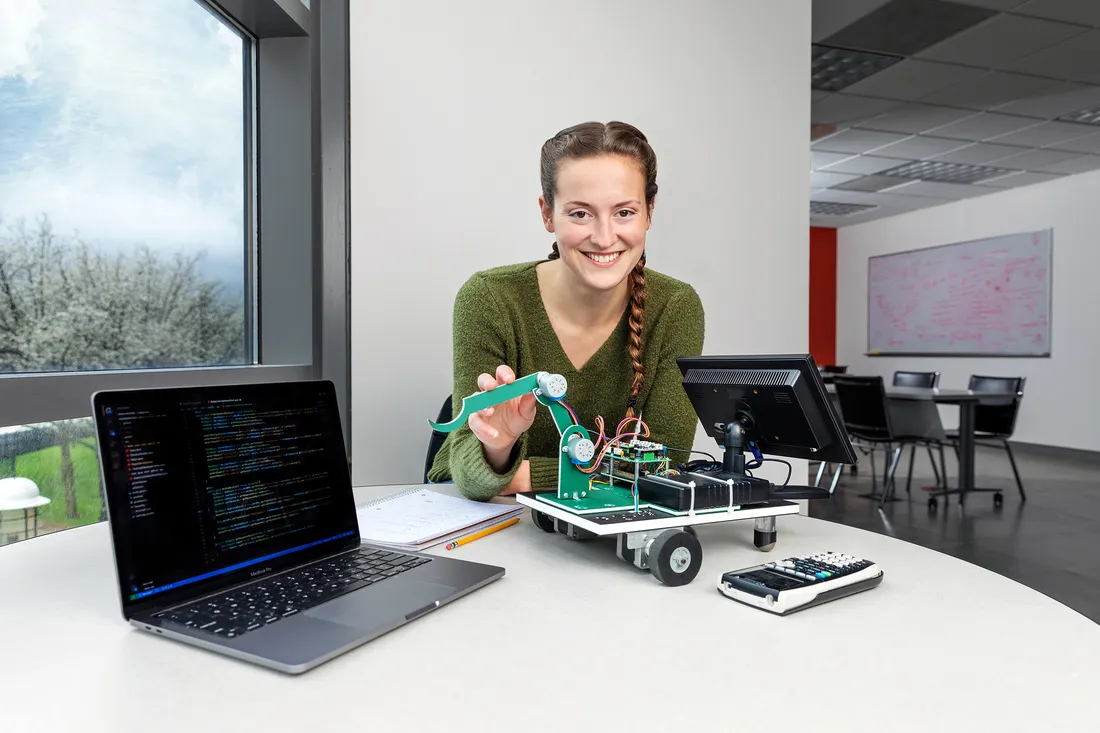 Caitlin Sanders working on a project in the life science center, smiling.