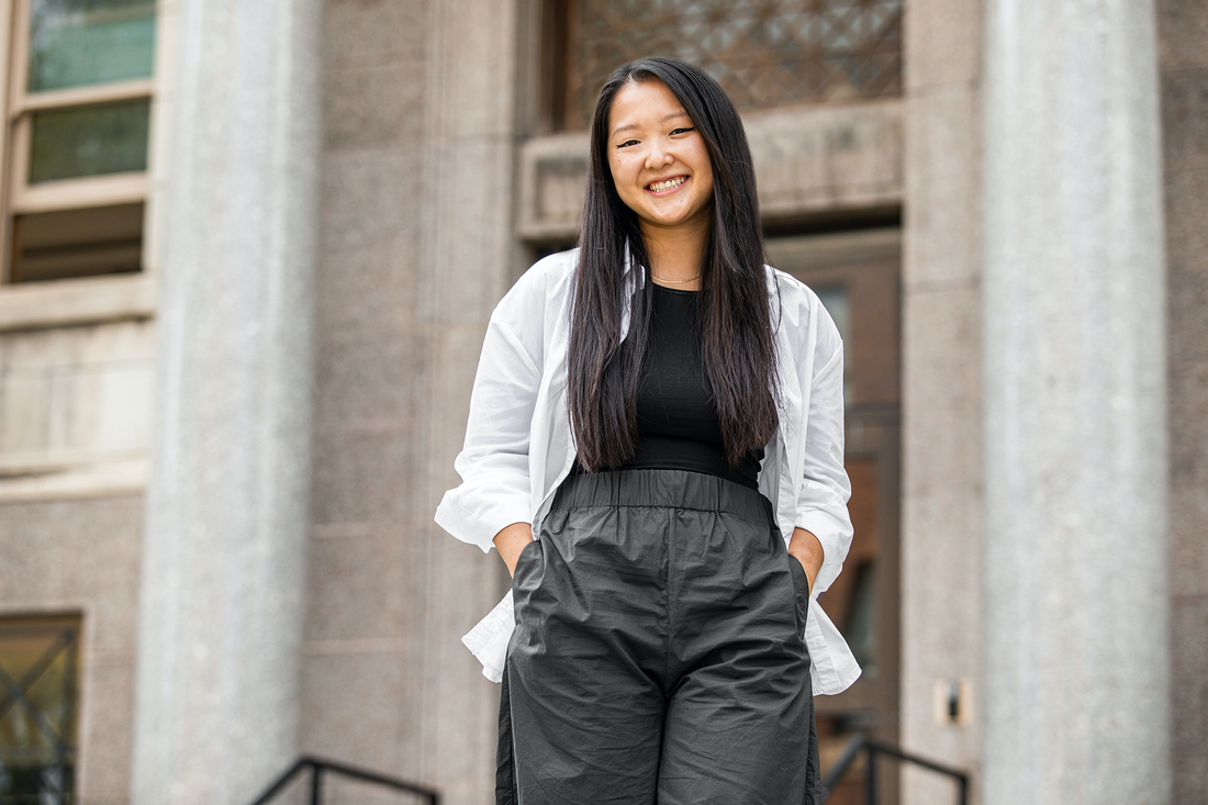 Li smiling on the steps.