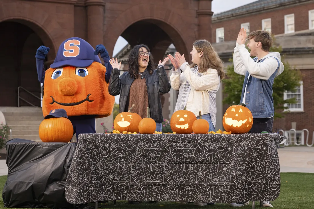 Students standing with Otto the Orange.