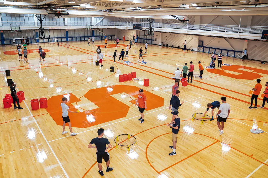 Students playing games at a Syracuse University basketball court.