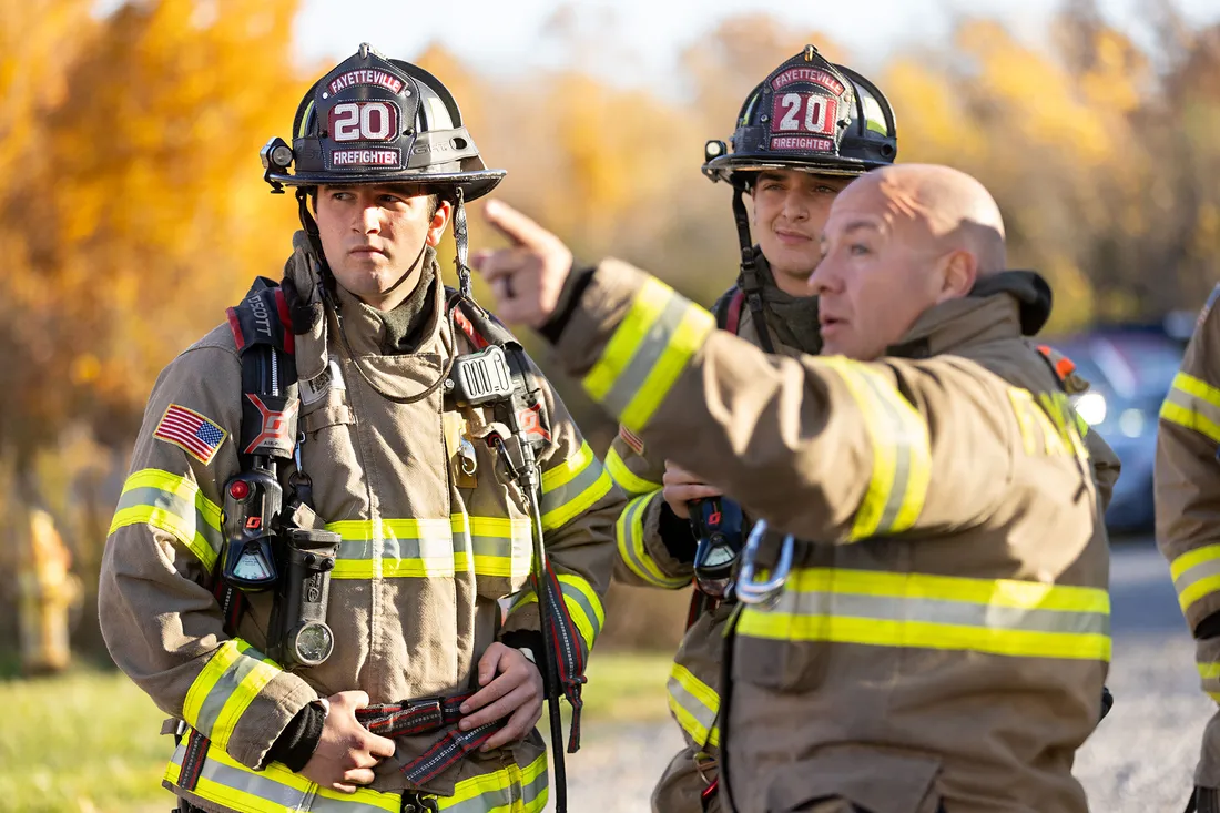Ryan Derkowski listening to fellow fire fighters.