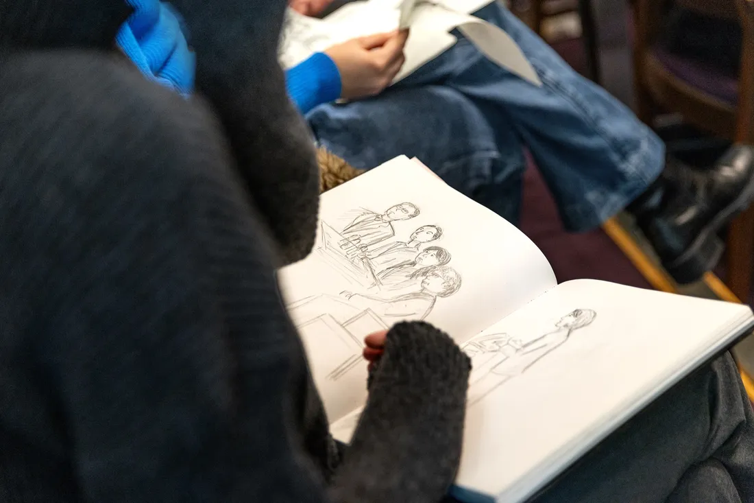 Close up of a courtroom sketch being drawn by an illustration major at a military court hearing.