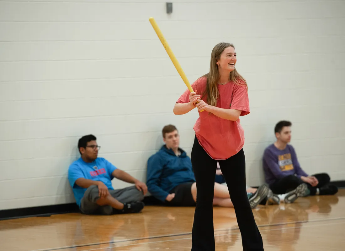 Students playing an intramural wiffleball game.