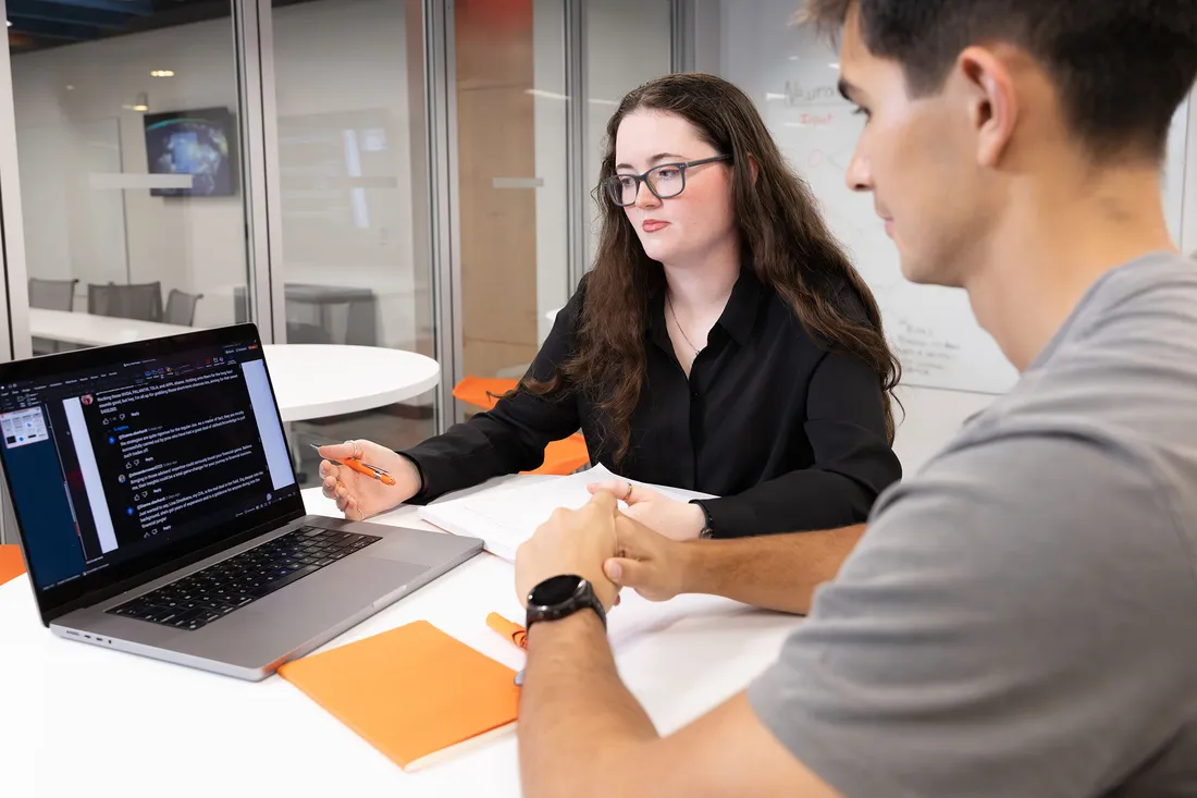 People looking at data on a computer together.