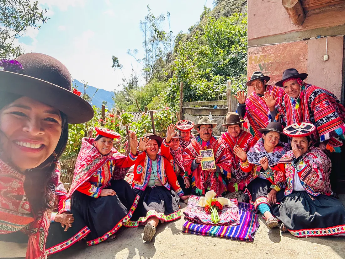People in traditional Peruvian clothing posing for a picture together.