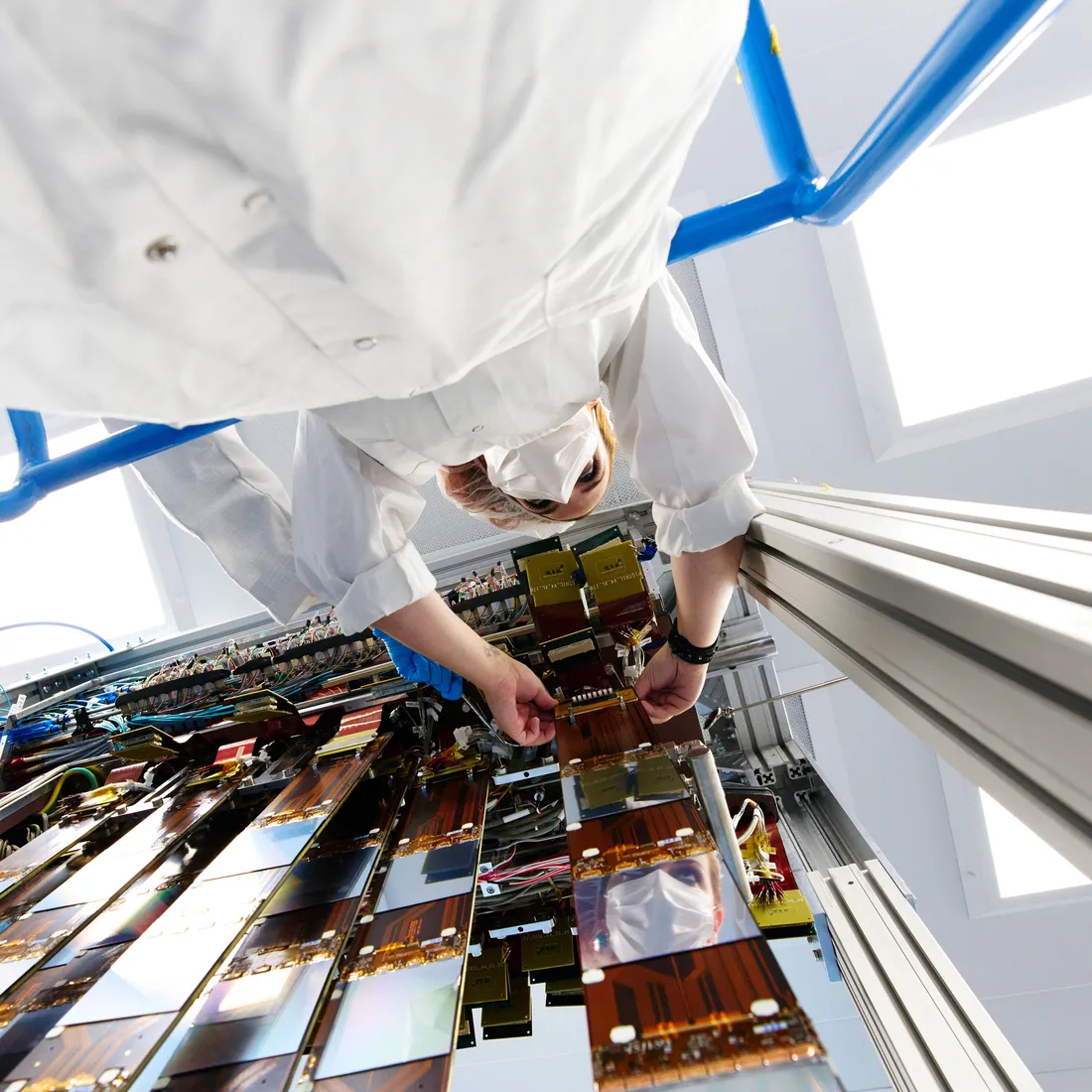 Scientist works on the Upstream Tracker in a clean room at CERN.