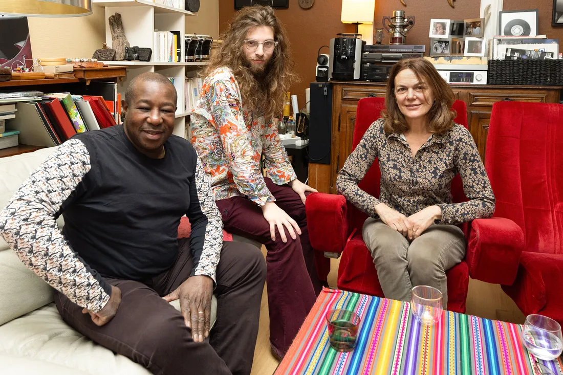 Student sitting down on couches with his hosts
