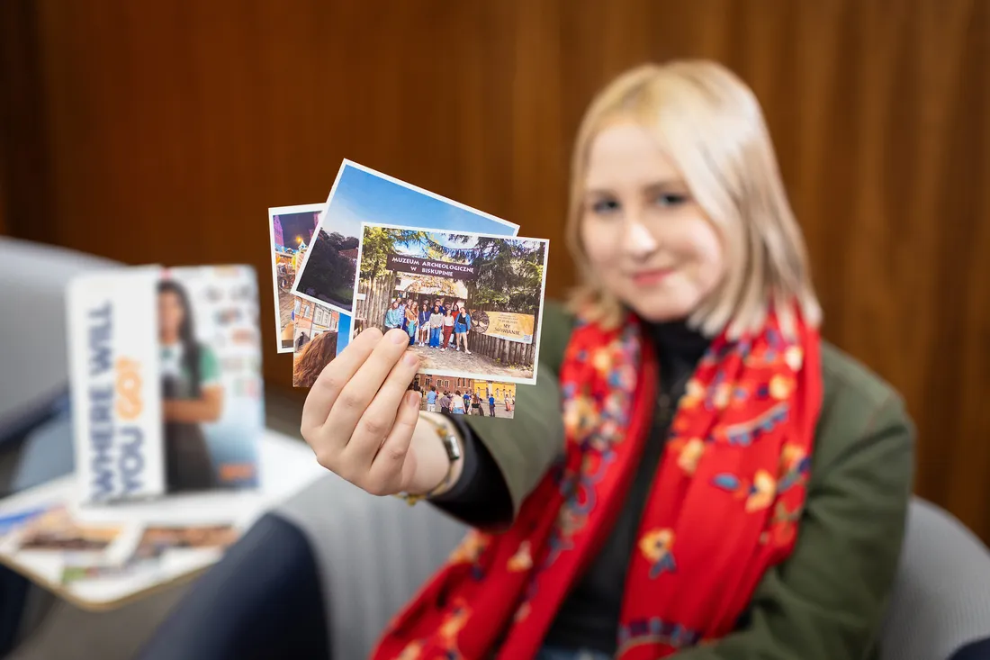 Anna Meehan holding up post cards.
