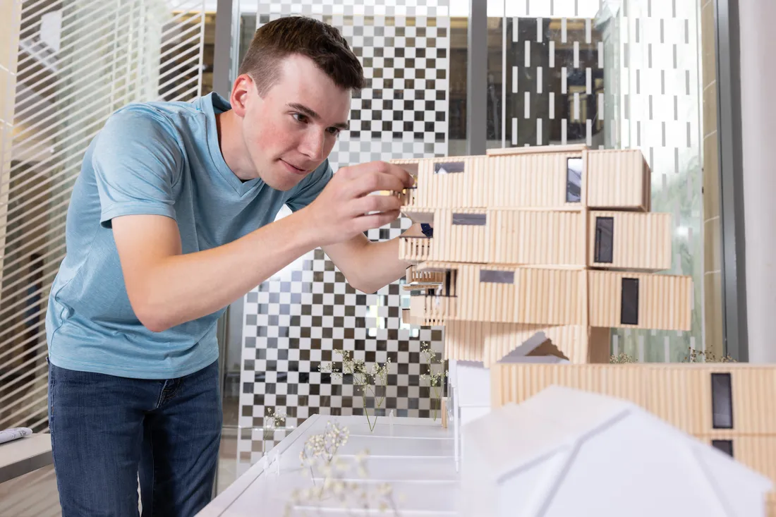 A person working on an Architectural model.