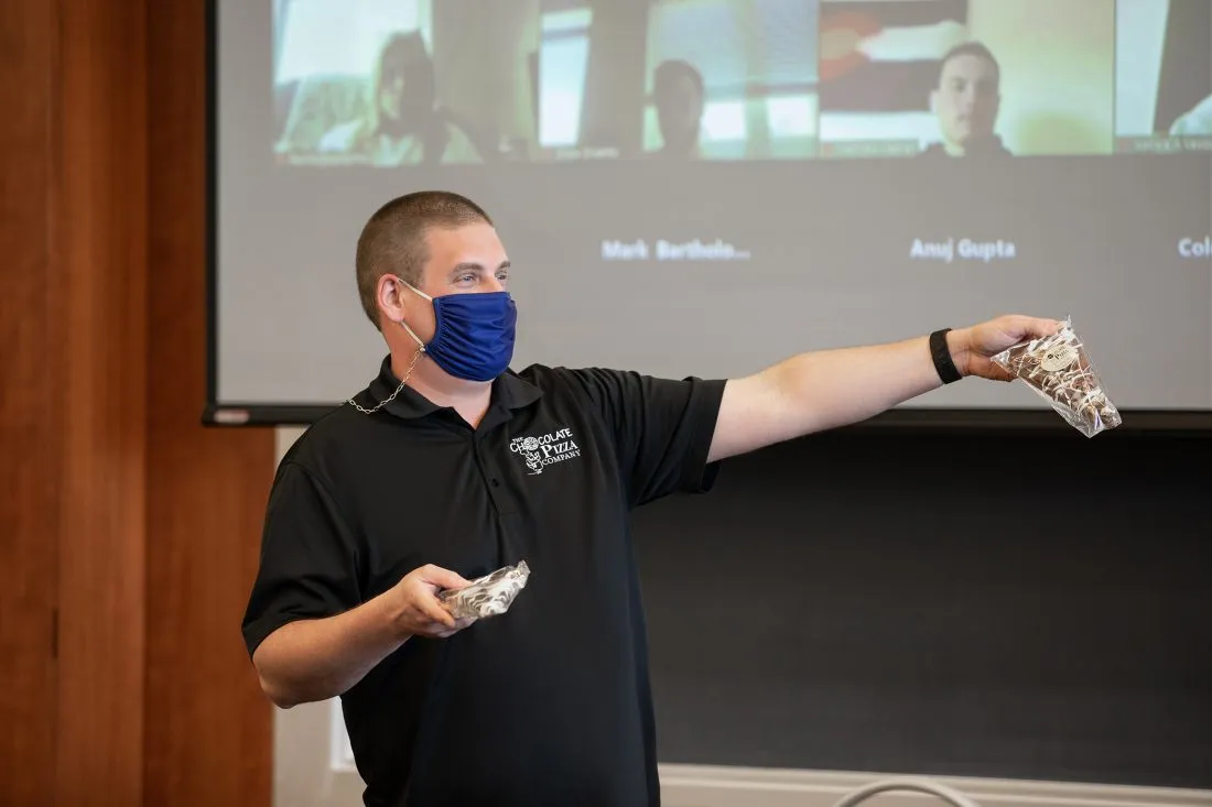 Alumni Ryan Novak speaks at the Whitman School of Management about his company, The Chocolate Pizza Company.